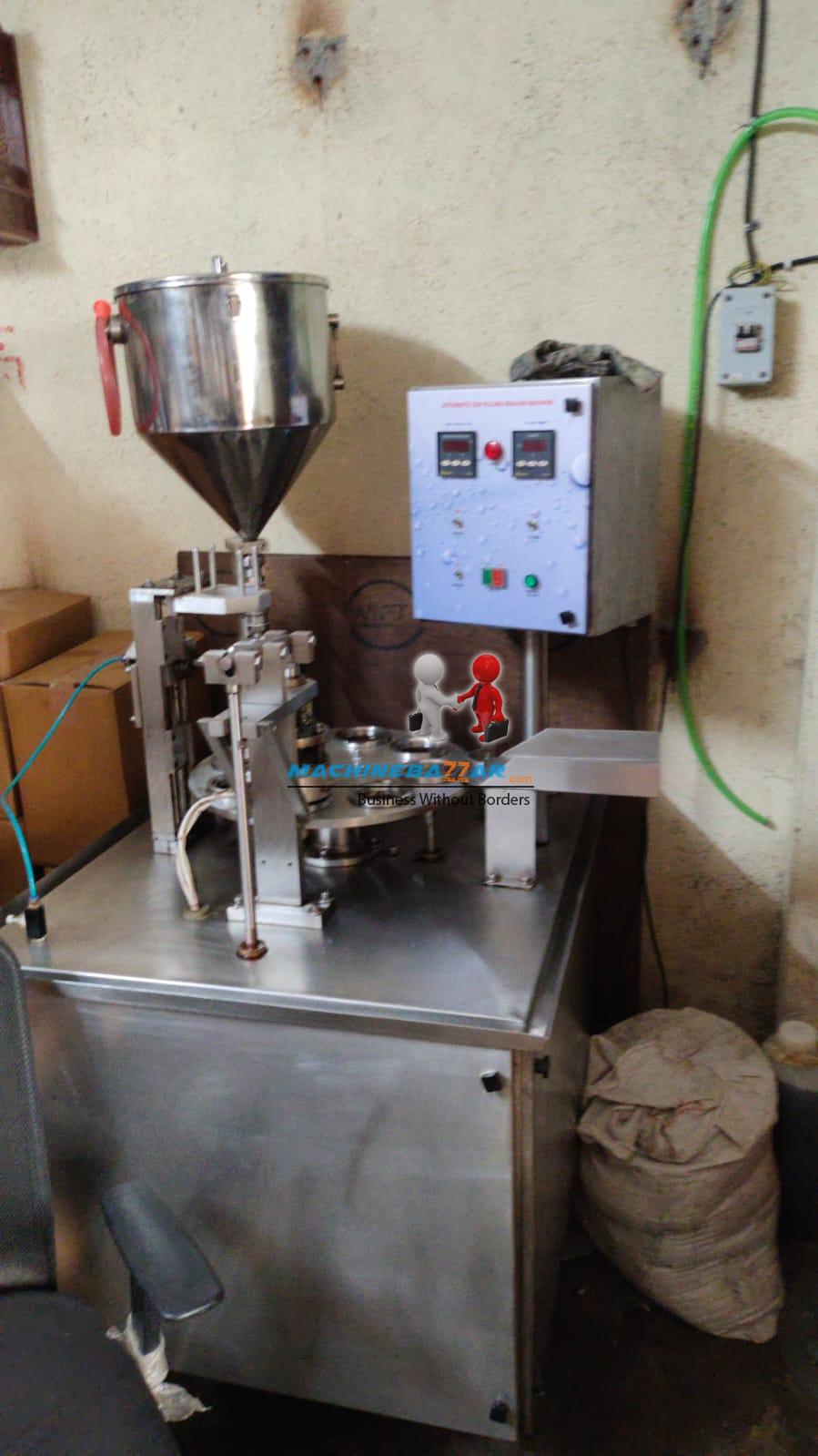 Automatic cup filling and cup sealing machine 